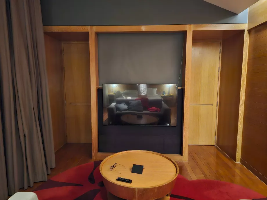 Room with a closed door separating the hallway and bathroom