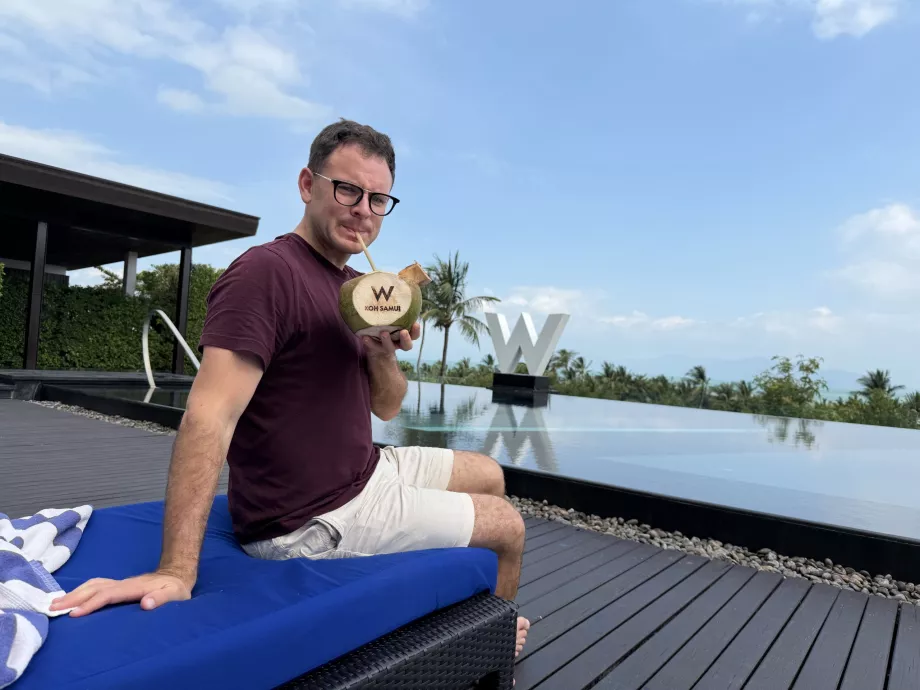 Me with a coconut with the letter "W" engraved on it by the pool