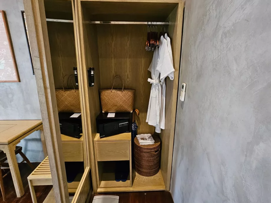 Wardrobe with bathrobes, safe, wicker bag and flip-flops