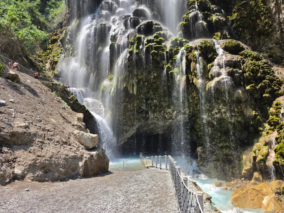 Waterfall and entrance to a large open cave