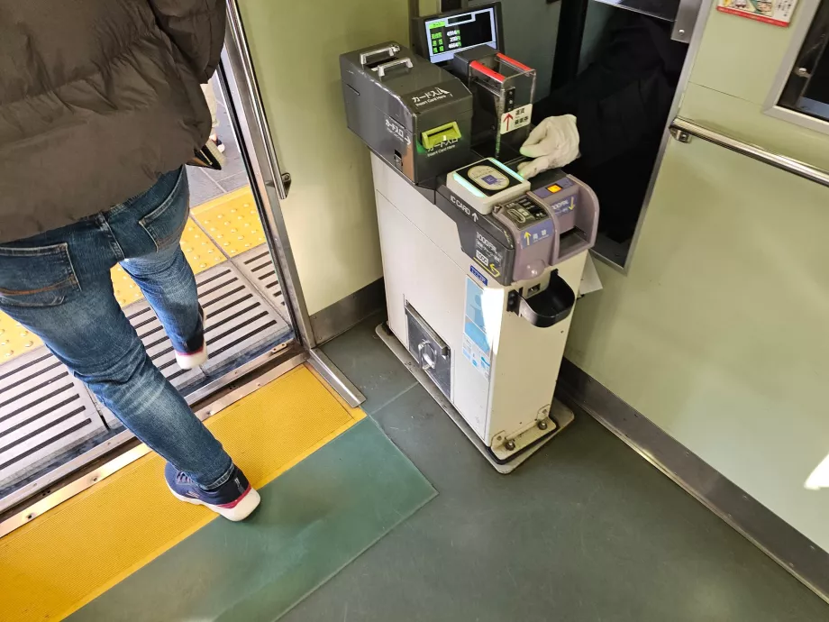 Paying the tram fare when getting off the tram