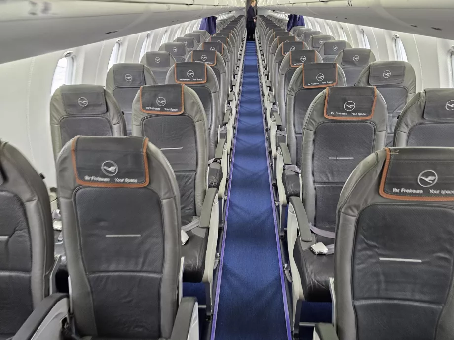 Business class cabin, economy class cabin in the background