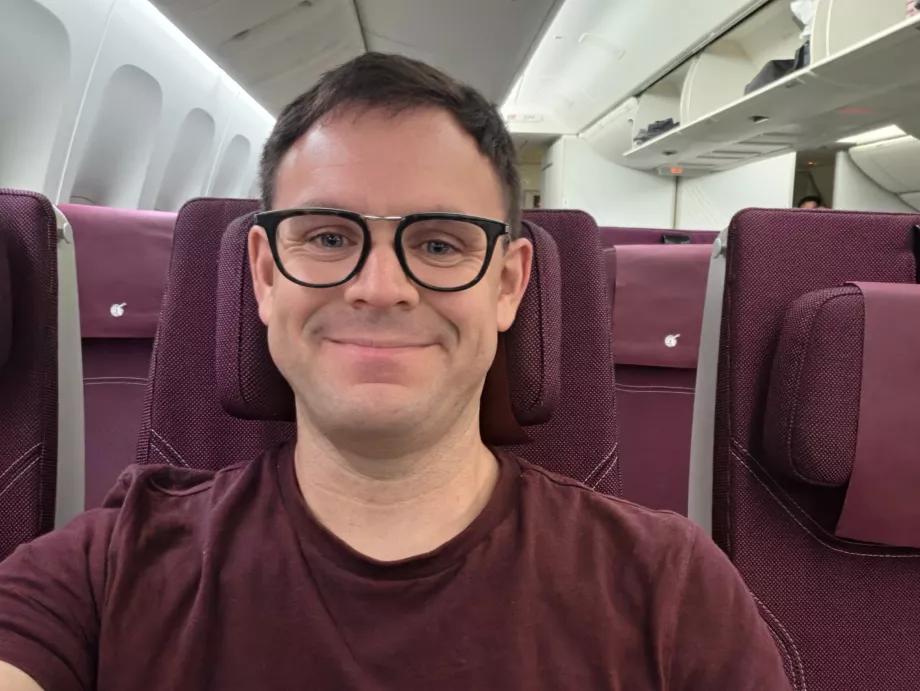 Me at Qatar Airways (my T-shirt matches the colour scheme of the cabin!)