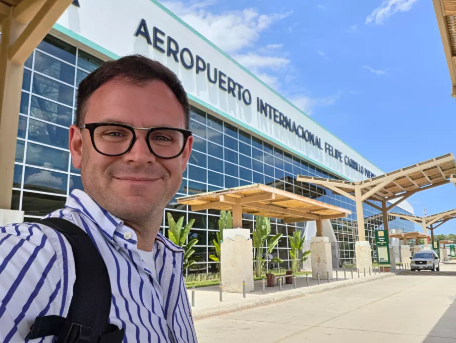 Me in front of the Tulum Airport terminal