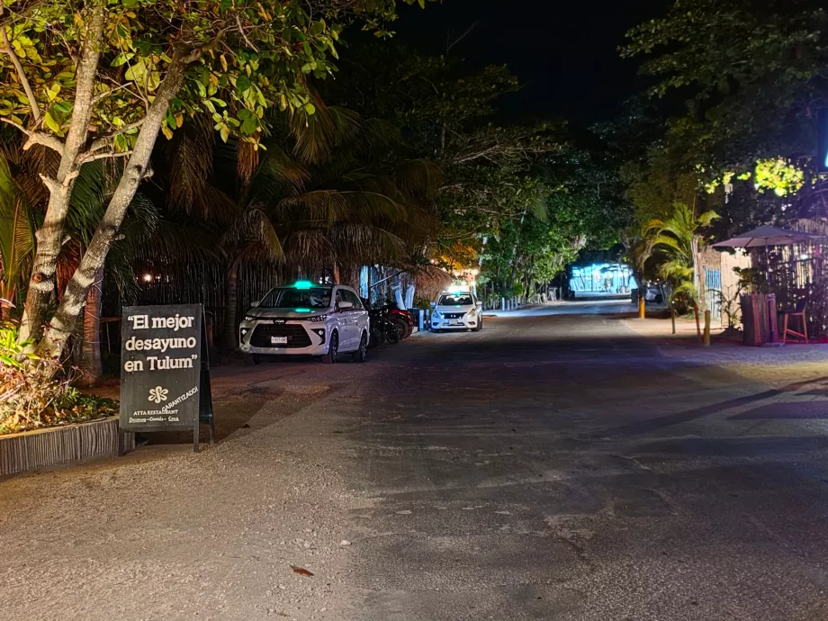 Taxis waiting along the main road at night