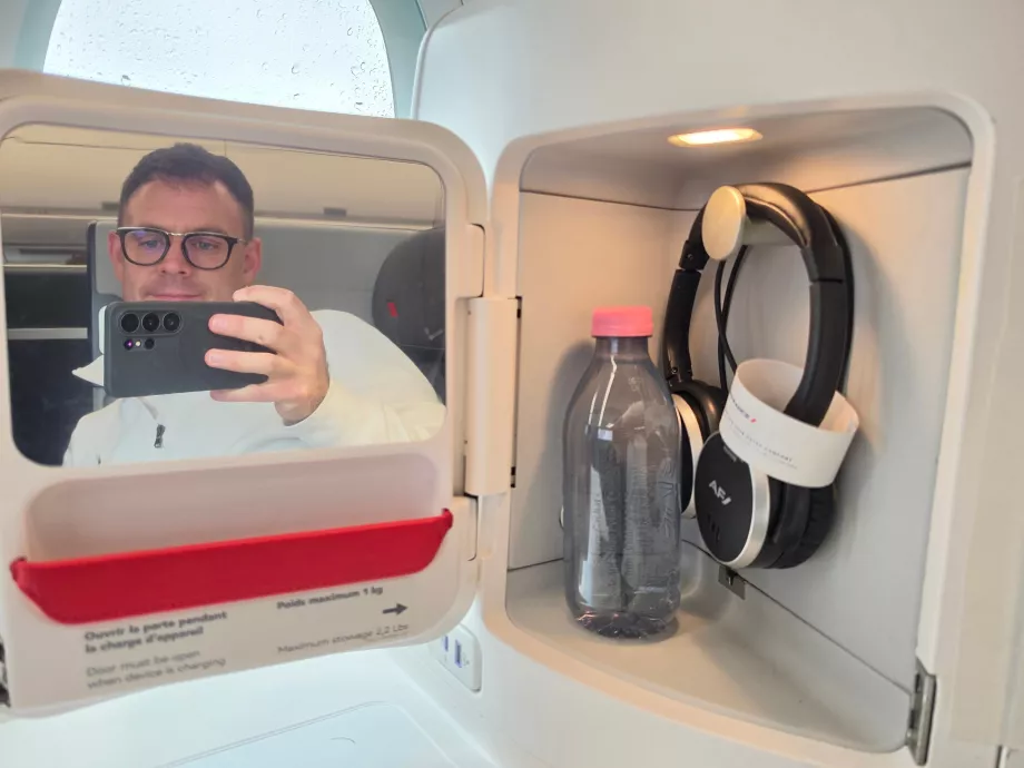 A mirror, headphones and a bottle of water