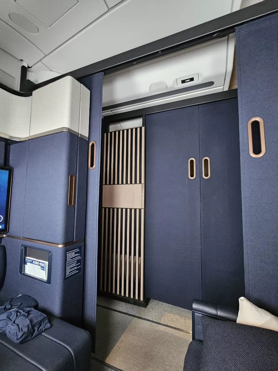 Sliding door between suite and aisle