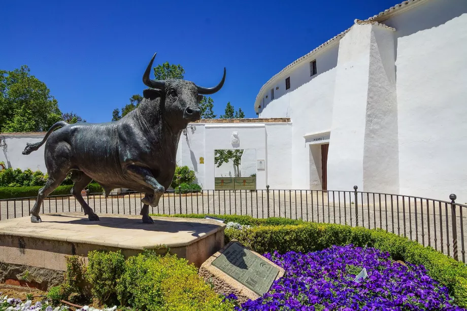 The statue of a bull in front of the Plaza de Toros