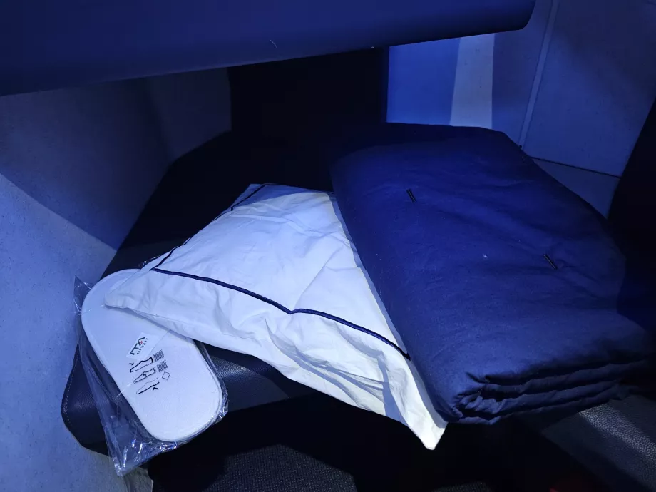 Pillow, blanket and slippers