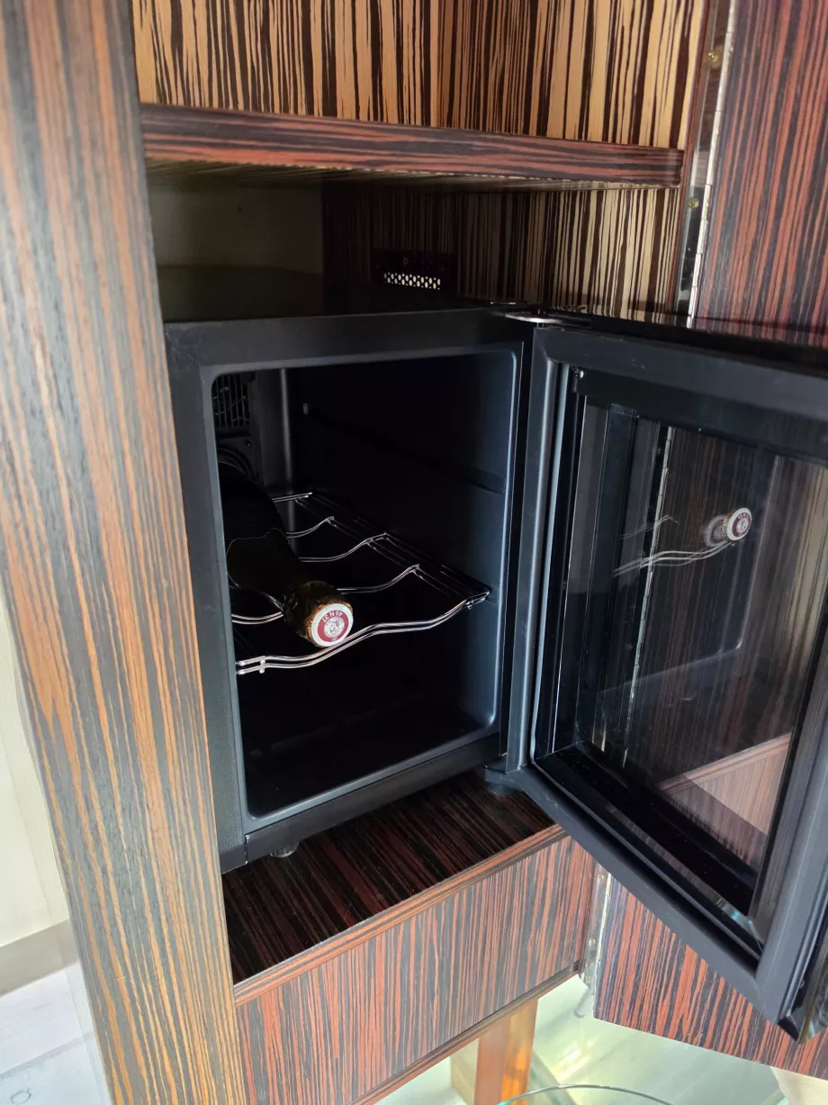 A fridge with sparkling wine in the tower