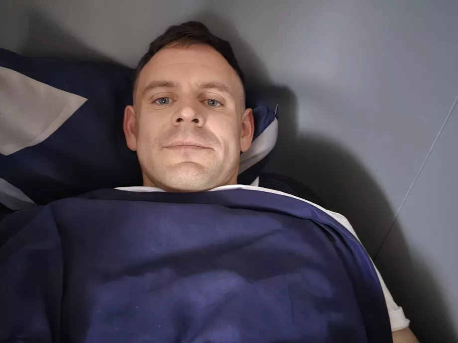 Christopher is lying in bed