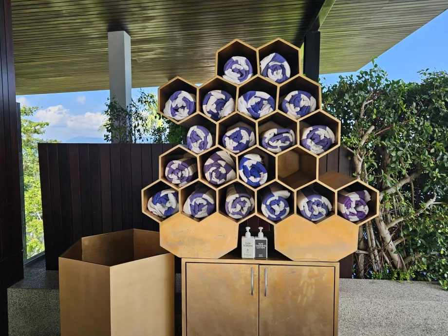 Towels and sunscreen by the pool